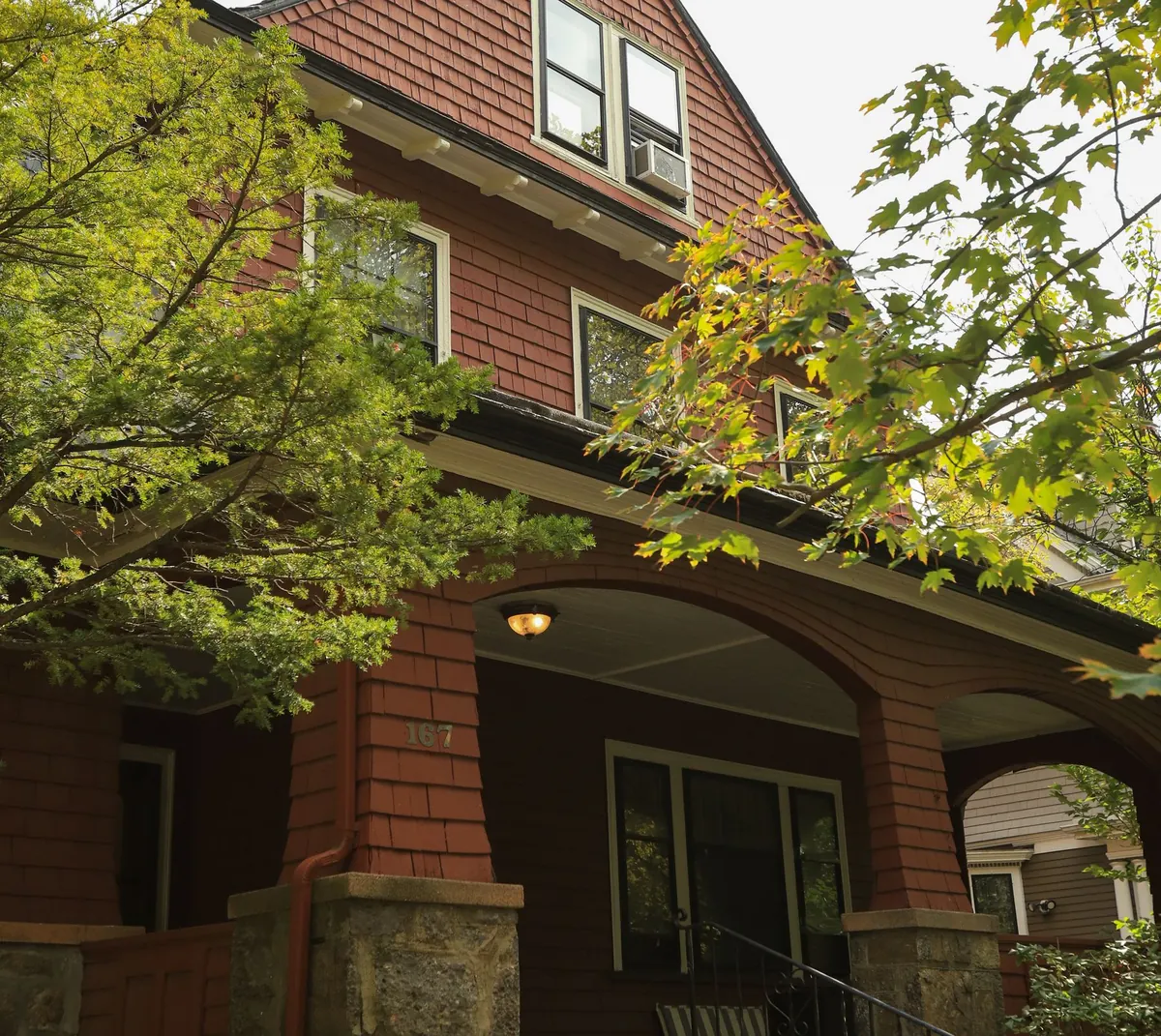 Welcoming brick home with a leafy front yard, representing the kinds of homes handyman work can support